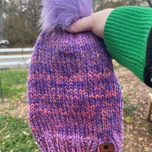 Hand knit beanie with a faux fur pom pom